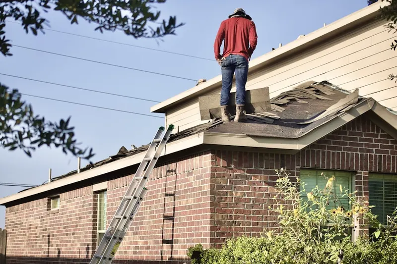 Professional roofer working on a residential roof in Speedway